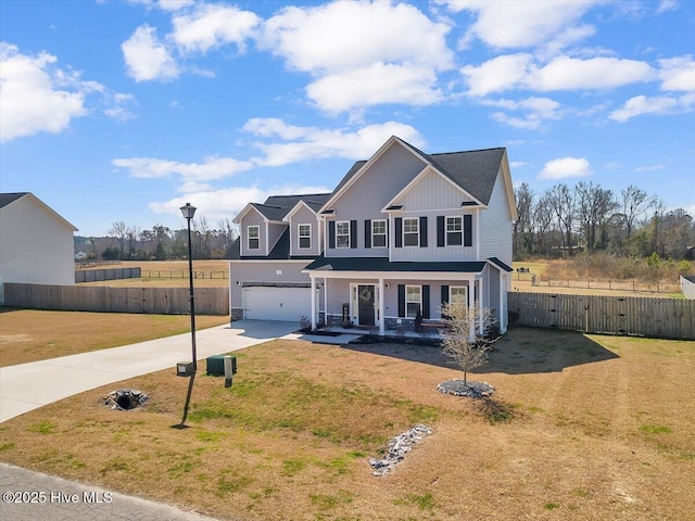 view of front of home featuring fence, driveway, covered porch, a front lawn, and a garage