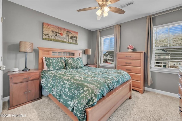 bedroom with visible vents, light colored carpet, a ceiling fan, and baseboards