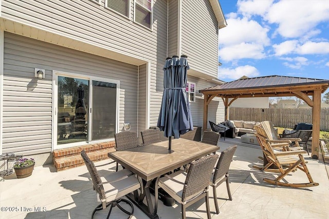 view of patio / terrace featuring a gazebo, outdoor dining area, outdoor lounge area, and fence