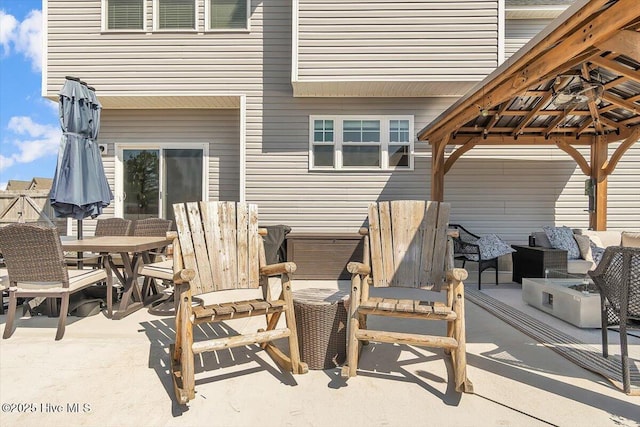 view of patio with a gazebo and outdoor dining area