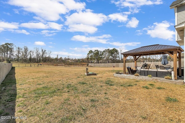 view of yard featuring a gazebo and a fenced backyard