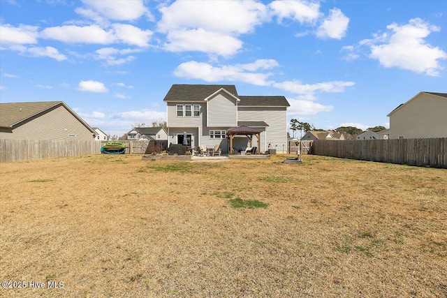 back of house featuring a gazebo, a yard, a fenced backyard, and a patio