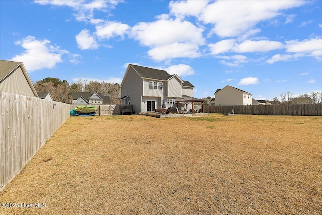 back of property featuring a gazebo, a yard, a patio, and a fenced backyard