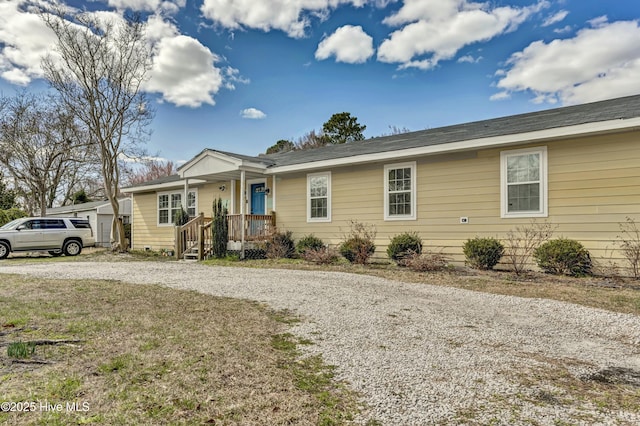 ranch-style house with gravel driveway