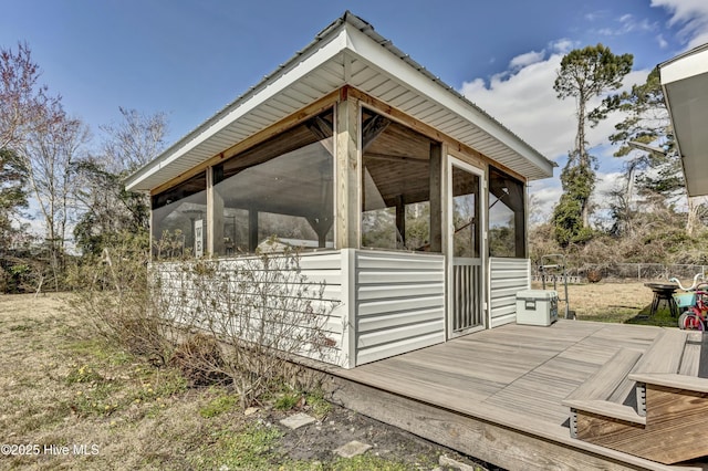 view of outbuilding with a sunroom