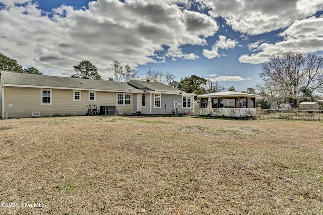 back of house featuring a yard and central AC unit