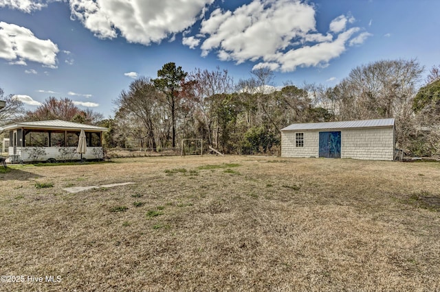 view of yard featuring an outbuilding and a playground