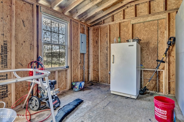 misc room with lofted ceiling and electric panel