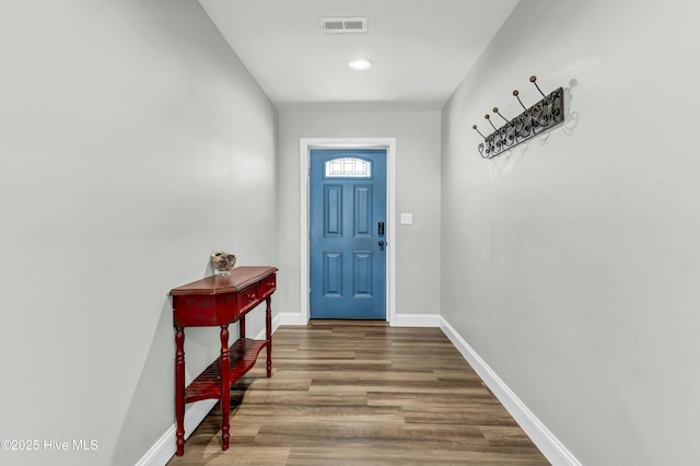 entryway featuring visible vents, wood finished floors, and baseboards