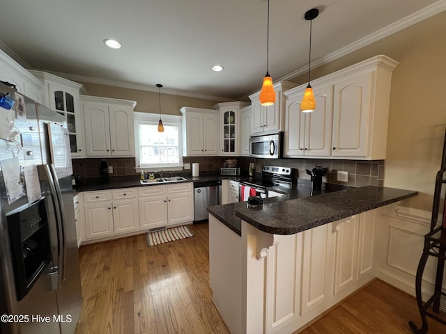 6725 Hemlock Ct, Sims, NC 27880 - kitchen with stainless steel appliances, a peninsula, light wood-type flooring, glass insert cabinets, and pendant lighting