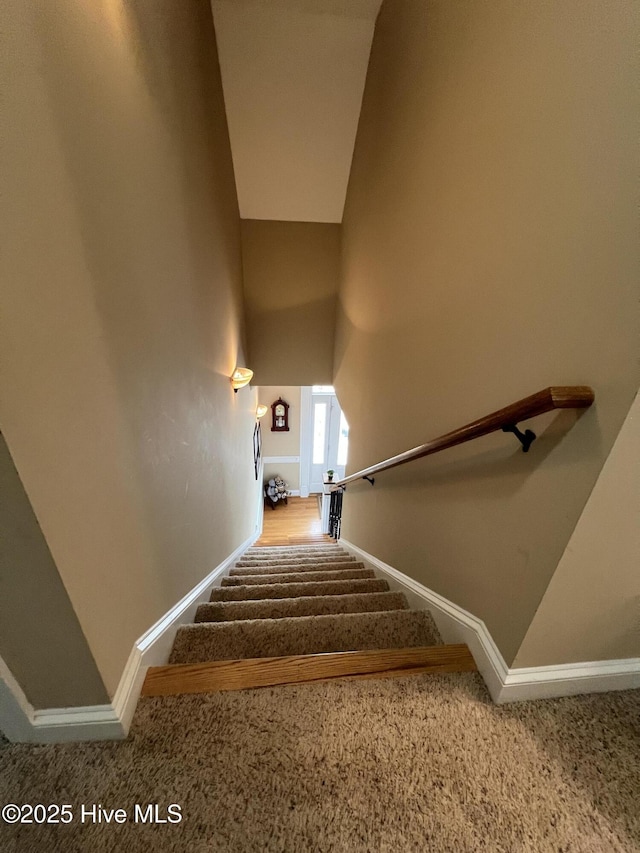 6725 Hemlock Ct, Sims, NC 27880 - stairway featuring high vaulted ceiling, baseboards, and carpet flooring