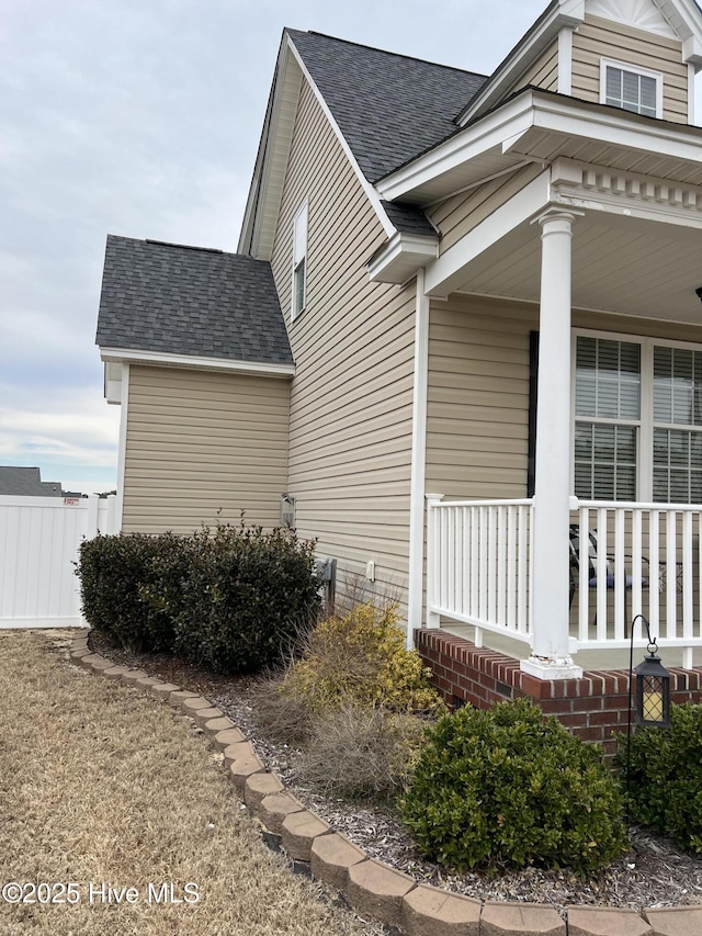 6725 Hemlock Ct, Sims, NC 27880 - view of home's exterior with roof with shingles, a porch, and fence