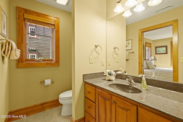 bathroom with visible vents, toilet, tile patterned flooring, baseboards, and vanity