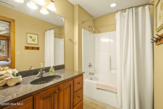 bathroom with visible vents, shower / tub combo with curtain, tile patterned floors, vanity, and a ceiling fan