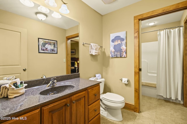 bathroom featuring tile patterned floors, baseboards, toilet, and vanity