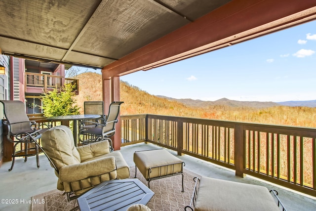 view of patio / terrace featuring outdoor dining space and a mountain view