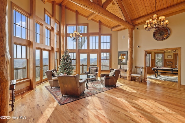 living room with french doors, a chandelier, wooden ceiling, and hardwood / wood-style flooring