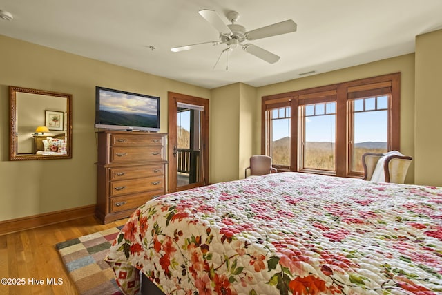 bedroom featuring visible vents, a ceiling fan, access to outside, light wood-style floors, and baseboards