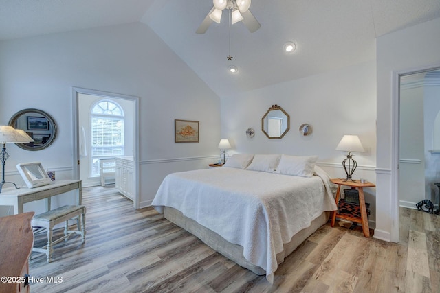 bedroom featuring a ceiling fan, vaulted ceiling, and light wood-style floors