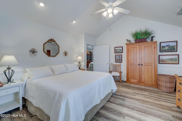 bedroom featuring ceiling fan, high vaulted ceiling, and light wood-style flooring