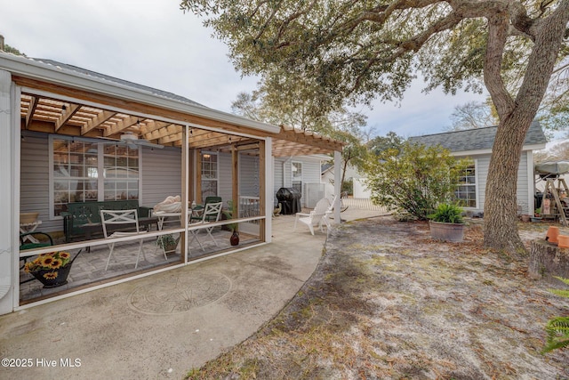 back of property with fence, a patio area, and a pergola