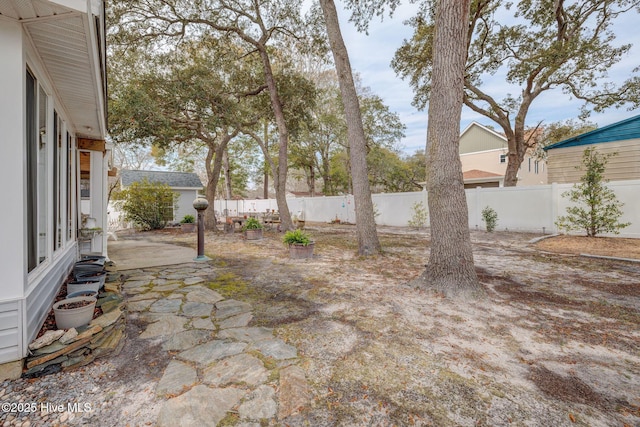 view of yard featuring a patio area and a fenced backyard