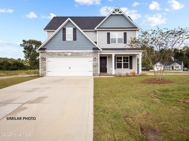 craftsman house with a front yard, concrete driveway, stone siding, and an attached garage