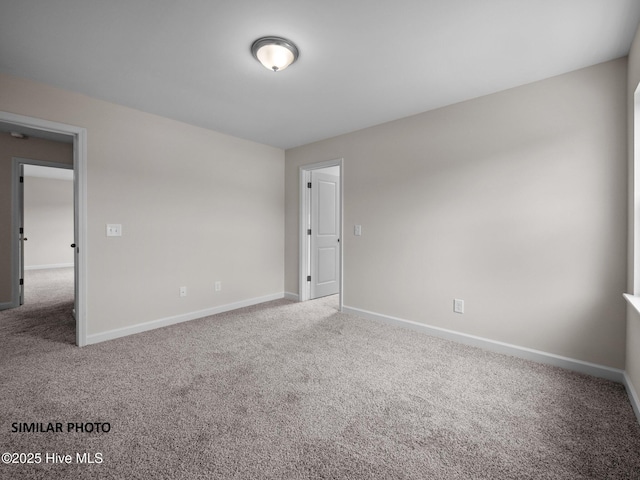 spare room with carpet flooring and baseboards