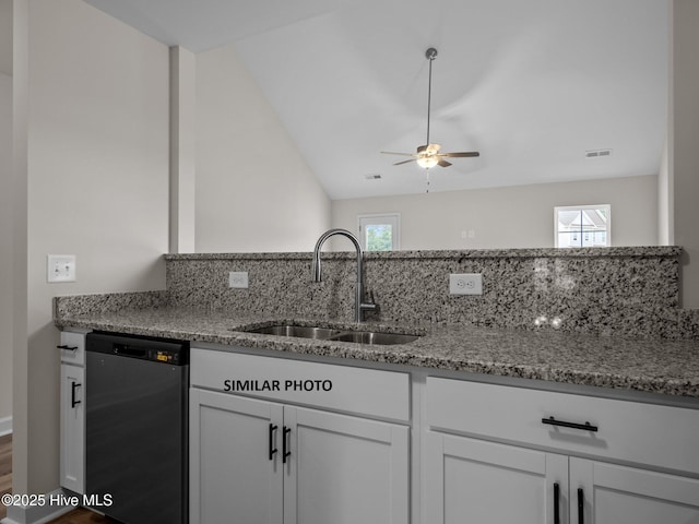 kitchen featuring visible vents, a sink, light stone counters, white cabinets, and dishwasher