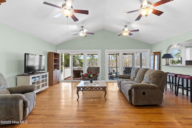 living area featuring wood finished floors, a wealth of natural light, and ceiling fan