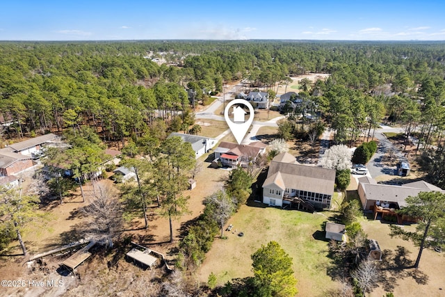 bird's eye view featuring a wooded view