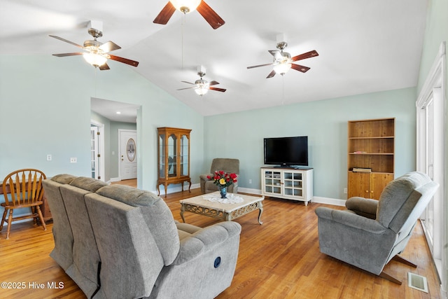 living room with light wood-type flooring, visible vents, baseboards, and a ceiling fan