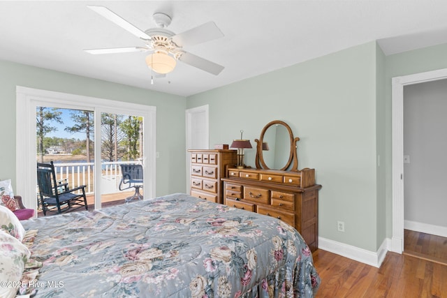 bedroom featuring access to exterior, ceiling fan, baseboards, and wood finished floors