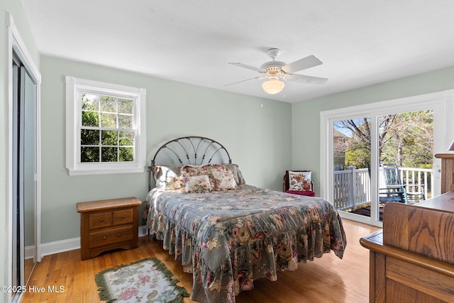 bedroom with access to exterior, light wood-style flooring, baseboards, and ceiling fan