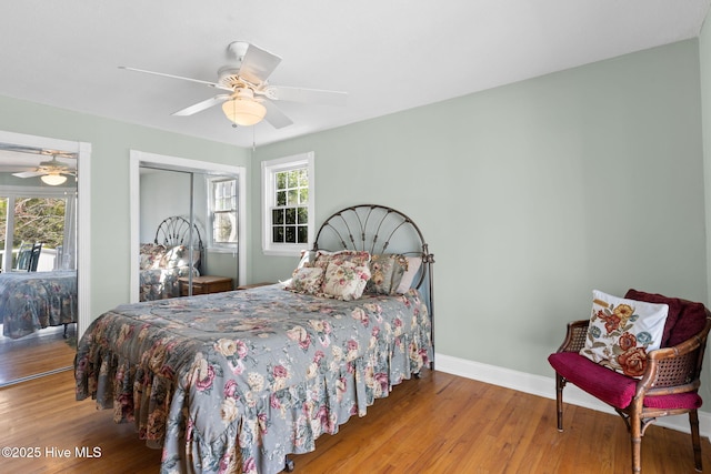 bedroom featuring wood finished floors, baseboards, a closet, and ceiling fan