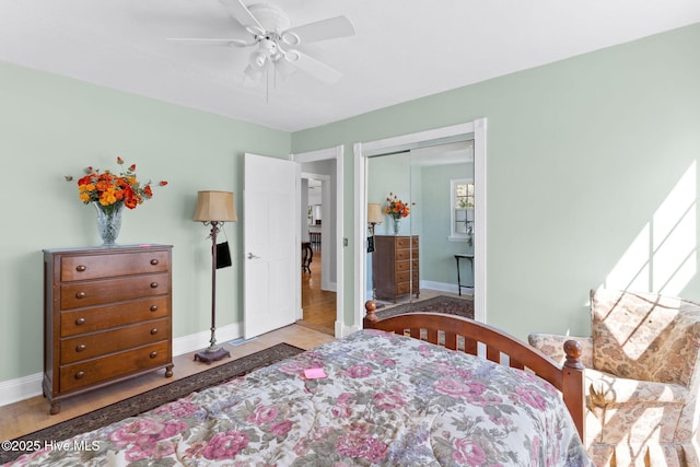 bedroom with a ceiling fan, baseboards, and a closet