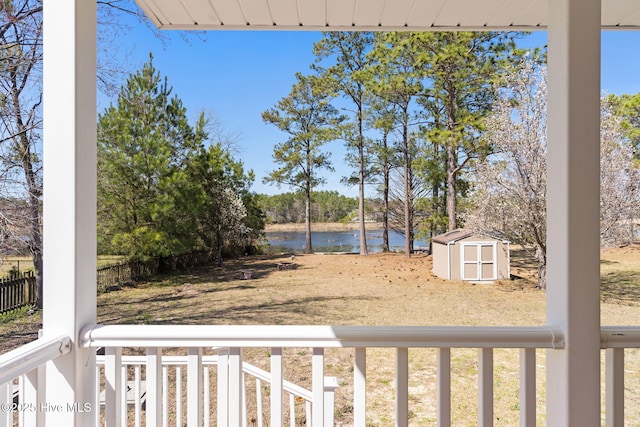 view of yard with a storage unit, an outdoor structure, and a water view