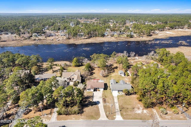 aerial view featuring a forest view and a water view