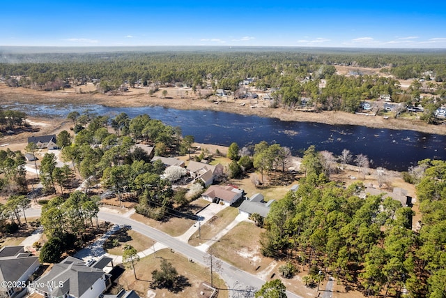 bird's eye view with a forest view and a water view