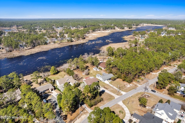 birds eye view of property with a forest view, a water view, and a residential view