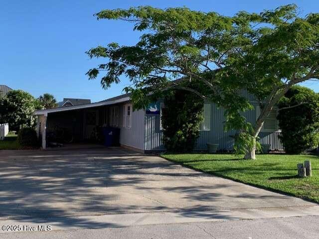 view of front of home with driveway and a front lawn