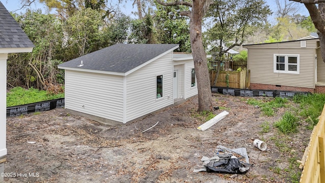 view of outbuilding with fence and an outbuilding