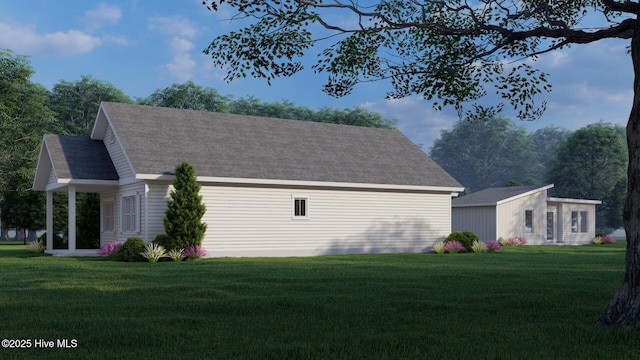 view of side of home with a yard and roof with shingles