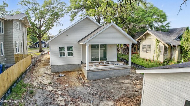 rear view of property with fence