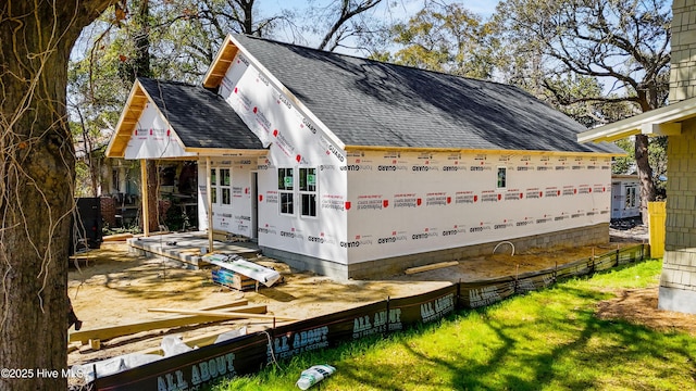 view of property exterior featuring a shingled roof