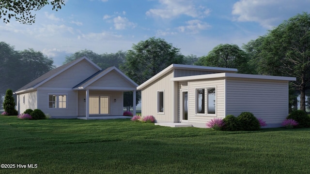 rear view of property featuring a yard