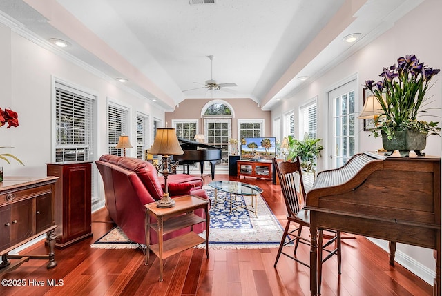 living area with dark wood-style floors, visible vents, recessed lighting, ceiling fan, and vaulted ceiling