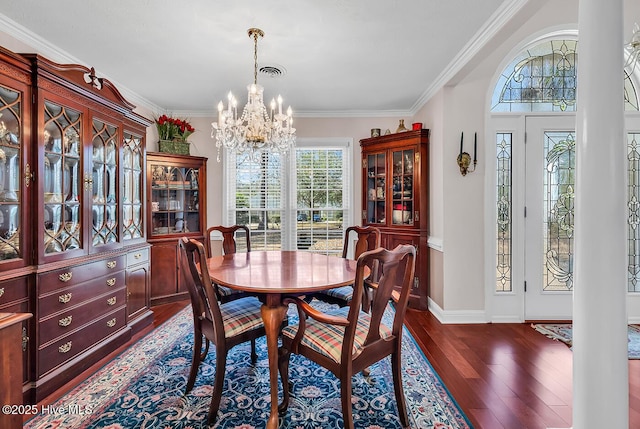 dining space featuring visible vents, an inviting chandelier, dark wood-style floors, and ornamental molding