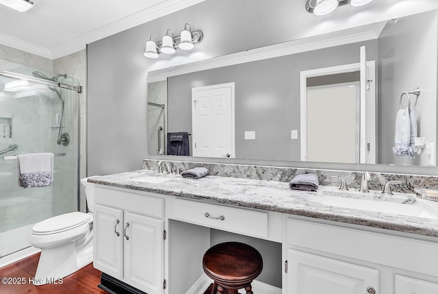 full bath featuring ornamental molding, a stall shower, wood finished floors, and a sink