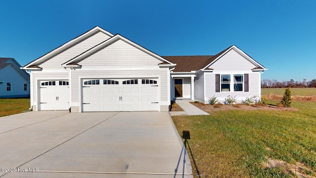 ranch-style home featuring a front yard, an attached garage, and driveway